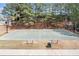 Community basketball court with benches, trash receptacle and surrounding mature trees for a shaded play area at 3225 Suffolk Dr, Cumming, GA 30041