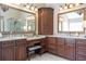 Luxurious bathroom with and sinks, granite countertops, dark cabinetry, and a glass shower at 3225 Suffolk Dr, Cumming, GA 30041