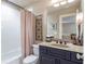 Bathroom with a combination shower and tub, vanity, and modern lighting at 3225 Suffolk Dr, Cumming, GA 30041