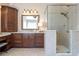 Modern bathroom with a tiled glass shower, dark cabinetry, and plenty of counter space at 3225 Suffolk Dr, Cumming, GA 30041
