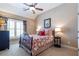Bedroom featuring a bed with a decorative bedspread, window with curtains, and carpet at 3225 Suffolk Dr, Cumming, GA 30041