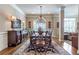 Elegant dining room with a chandelier, hardwood floors, and views into the living spaces at 3225 Suffolk Dr, Cumming, GA 30041