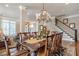 Formal dining area with a large wooden table, chandelier, and access to other living areas at 3225 Suffolk Dr, Cumming, GA 30041