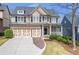 Charming two-story home with a brick and siding exterior, complemented by a well-manicured lawn at 3225 Suffolk Dr, Cumming, GA 30041