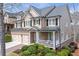 Beautiful two-story home featuring a brick facade, a two-car garage, and a welcoming front porch at 3225 Suffolk Dr, Cumming, GA 30041