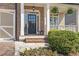 Inviting front entrance with brick steps, black-framed door, decorative lanterns, and lush landscaping at 3225 Suffolk Dr, Cumming, GA 30041