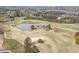 An aerial view shows a lush golf course featuring a scenic pond and well-manicured fairways surrounded by trees at 3225 Suffolk Dr, Cumming, GA 30041