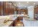 Beautiful kitchen with granite countertops, stainless steel appliances, dark wood cabinets and island at 3225 Suffolk Dr, Cumming, GA 30041