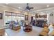 Open-concept living room with a ceiling fan and large windows flows into the kitchen at 3225 Suffolk Dr, Cumming, GA 30041