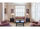 Cozy living room with neutral tones, plantation shutters, and comfortable seating arrangement at 3225 Suffolk Dr, Cumming, GA 30041