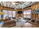 Living room featuring exposed beams, a large TV, and comfortable seating at 3225 Suffolk Dr, Cumming, GA 30041