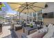 Relaxing outdoor patio featuring comfortable seating under a large umbrella and mounted TV at 3225 Suffolk Dr, Cumming, GA 30041