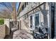 Private back patio with seating area, featuring a brick surround and wrought iron fence at 6940 Roswell Rd # 5B, Atlanta, GA 30328