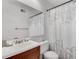 Bathroom featuring a shower with leafy patterned curtain, a modern sink, and a large mirror at 6940 Roswell Rd # 5B, Atlanta, GA 30328