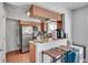 Kitchen area with stainless steel refrigerator, oven, granite counter tops and hardwood flooring at 6940 Roswell Rd # 5B, Atlanta, GA 30328