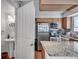 View of the kitchen featuring granite countertops and appliances, with a bathroom visible through the doorway at 6940 Roswell Rd # 5B, Atlanta, GA 30328