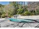 Community outdoor swimming pool with lush greenery and shaded areas at 6940 Roswell Rd # 5B, Atlanta, GA 30328