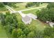 A well-manicured lawn, towering trees, and lengthy driveway accent this two-story home near a quiet neighborhood road at 1585 Elliott Rd, Mcdonough, GA 30252