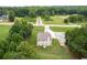 Wide aerial view of property, highlighting the house, driveway and surrounding greenery at 1585 Elliott Rd, Mcdonough, GA 30252