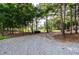 View of gravel backyard with trees and plenty of space for outdoor activities at 1585 Elliott Rd, Mcdonough, GA 30252