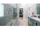 Beautiful bathroom with grey tiling, glass shower, marble countertop vanity and walk in closet at 1585 Elliott Rd, Mcdonough, GA 30252