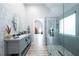 Bright bathroom featuring double sink vanity with marble counters, large glass shower and modern finishes at 1585 Elliott Rd, Mcdonough, GA 30252
