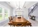 Dining room featuring a wooden table and plank flooring, with views into other living spaces at 1585 Elliott Rd, Mcdonough, GA 30252