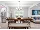 Bright dining room with modern chandelier, stainless appliances and an open plan at 1585 Elliott Rd, Mcdonough, GA 30252