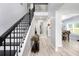 Grand entryway with hardwood floors, black staircase, and abundant natural light at 1585 Elliott Rd, Mcdonough, GA 30252