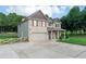 Charming two-story home with brick and siding exterior, featuring a two-car garage and well-manicured lawn at 1585 Elliott Rd, Mcdonough, GA 30252