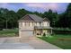 Charming two-story home featuring a brick facade, attached garage, covered porch, and beautifully maintained lawn at 1585 Elliott Rd, Mcdonough, GA 30252
