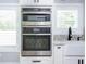 Modern kitchen featuring stainless steel oven and microwave appliances and white cabinets at 1585 Elliott Rd, Mcdonough, GA 30252