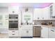 Bright kitchen featuring white cabinets, stainless steel appliances, and granite countertops at 1585 Elliott Rd, Mcdonough, GA 30252