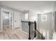 Upstairs landing with wrought iron railing, hardwood floors, and decorative chandelier at 1585 Elliott Rd, Mcdonough, GA 30252