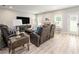 A roomy living room with laminate wood flooring, comfortable couches, and natural light at 1585 Elliott Rd, Mcdonough, GA 30252