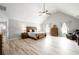 Bright main bedroom featuring vaulted ceiling, wood floors, large bed, and sitting area at 1585 Elliott Rd, Mcdonough, GA 30252