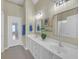 Bathroom featuring double sinks, white cabinets, and framed mirrors at 206 Glens Loop, Woodstock, GA 30188