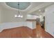 Bright dining area open to the kitchen featuring modern lighting, wood floors, and fresh paint at 206 Glens Loop, Woodstock, GA 30188