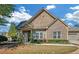 Charming exterior of a single Gathering home featuring a well-manicured lawn and a blend of brick and siding details at 206 Glens Loop, Woodstock, GA 30188