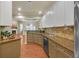 Open concept kitchen featuring granite counters, tile backsplash, stainless appliances and breakfast bar at 206 Glens Loop, Woodstock, GA 30188