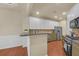 Well-appointed kitchen featuring granite countertops, stainless steel appliances, and white cabinets at 206 Glens Loop, Woodstock, GA 30188