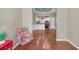View of an open floor plan with hardwood floors, living area, dining area, and kitchen at 206 Glens Loop, Woodstock, GA 30188
