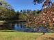 Scenic pond with a small bridge and cherry blossoms in a beautiful community setting at 206 Glens Loop, Woodstock, GA 30188