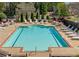 Community swimming pool surrounded by lounge chairs and tables with umbrellas at 206 Glens Loop, Woodstock, GA 30188