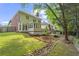 Landscaped backyard with lush green lawn and mature trees at 2462 Chestnut Lndg, Atlanta, GA 30360