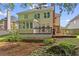 Backyard featuring a deck with grill, landscaping, and mature trees at 2462 Chestnut Lndg, Atlanta, GA 30360