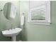 Powder room features a pedestal sink, neutral paint and classic fixtures at 2462 Chestnut Lndg, Atlanta, GA 30360