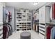 Spacious walk-in closet with custom shelving and drawers for optimal storage, and a central ottoman at 2462 Chestnut Lndg, Atlanta, GA 30360