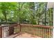 Wooden deck with a grill overlooks the lush backyard at 2462 Chestnut Lndg, Atlanta, GA 30360