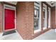 Close-up of the bright red front door of a brick home at 2462 Chestnut Lndg, Atlanta, GA 30360